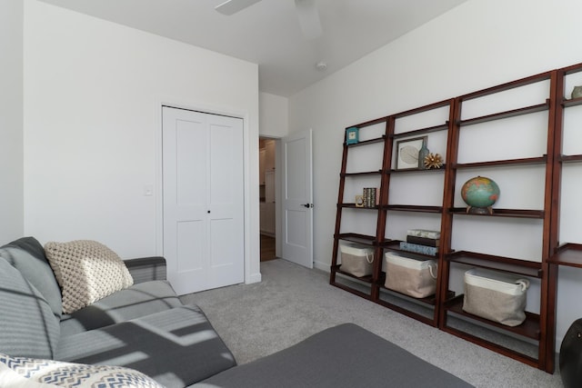 living room with ceiling fan and carpet