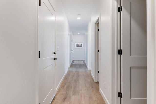 corridor with light hardwood / wood-style flooring