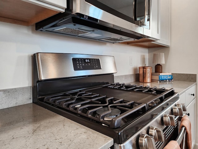 room details with white cabinets and appliances with stainless steel finishes