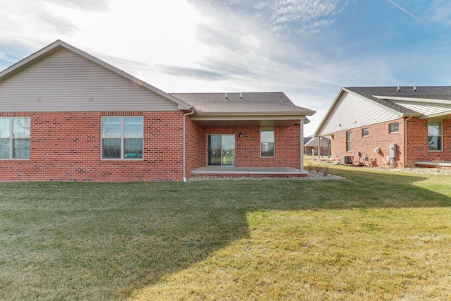 rear view of property featuring a patio area and a lawn