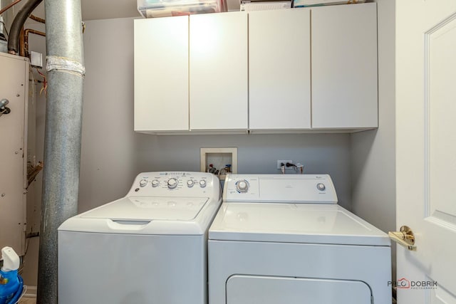 laundry area featuring cabinets and washing machine and clothes dryer