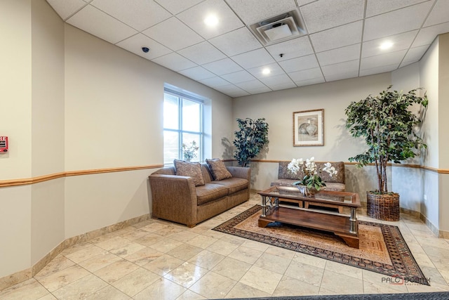 living room featuring a paneled ceiling