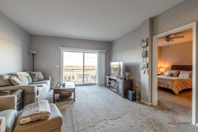 living room with vaulted ceiling, ceiling fan, and carpet