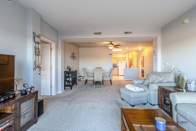 living room featuring light carpet and ceiling fan