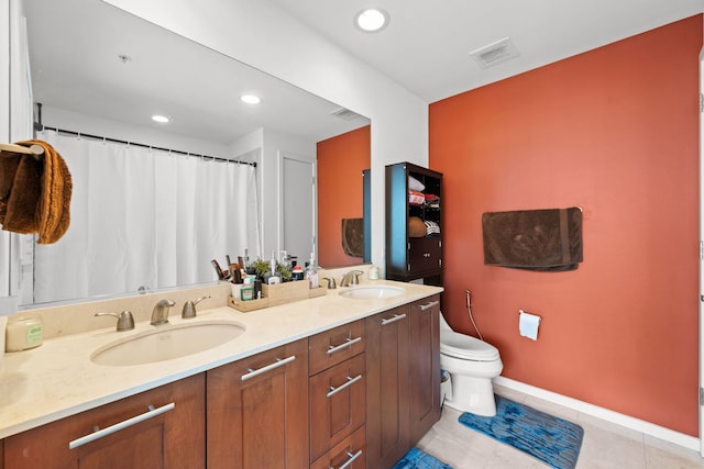 bathroom featuring tile patterned floors, vanity, and toilet