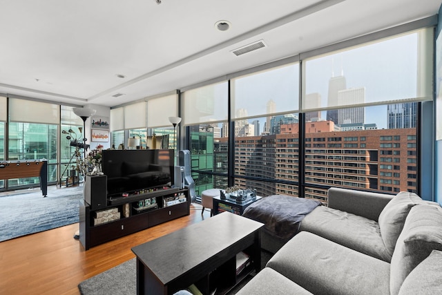 living room with hardwood / wood-style flooring and floor to ceiling windows