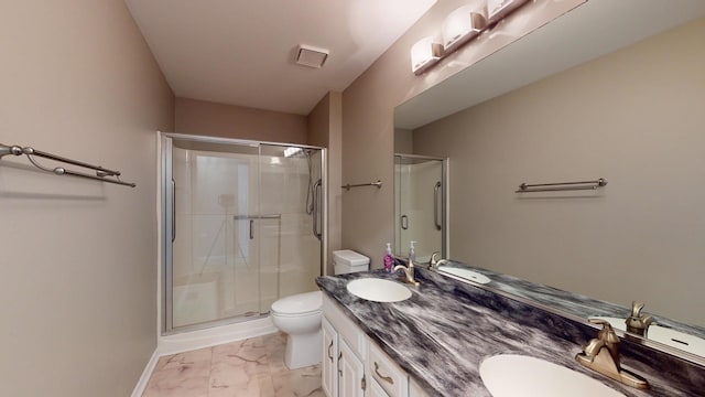 bathroom featuring vanity, toilet, and an enclosed shower