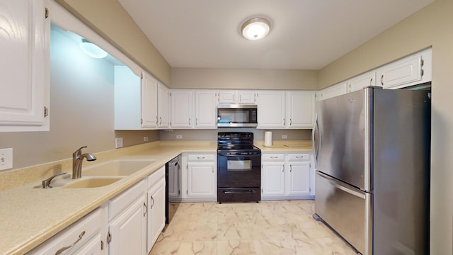 kitchen featuring white cabinetry, appliances with stainless steel finishes, and sink