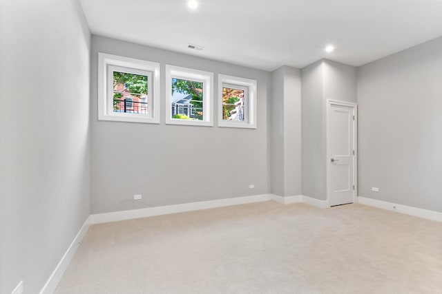 unfurnished room featuring light carpet