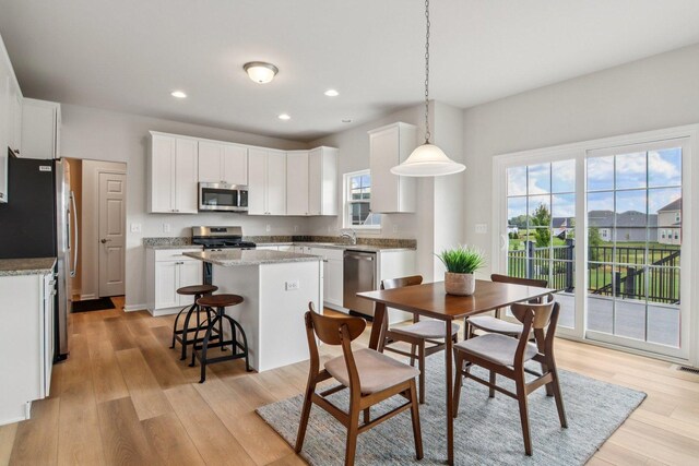 607 Virginia St, Elburn, IL 60119 - kitchen featuring stainless steel appliances, a kitchen island, light wood finished floors, white cabinetry, and recessed lighting