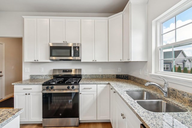 607 Virginia St, Elburn, IL 60119 - kitchen with appliances with stainless steel finishes, white cabinets, and light stone counters