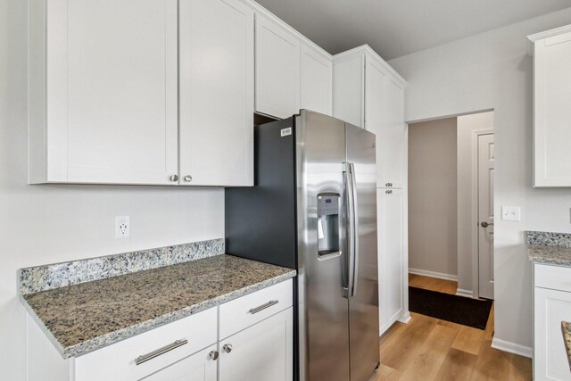 607 Virginia St, Elburn, IL 60119 - kitchen with stainless steel fridge with ice dispenser, light wood finished floors, white cabinets, and light stone counters