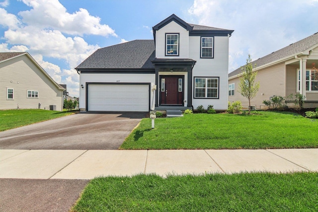 607 Virginia St, Elburn, IL 60119 - traditional home featuring asphalt driveway, a garage, a front yard, and roof with shingles