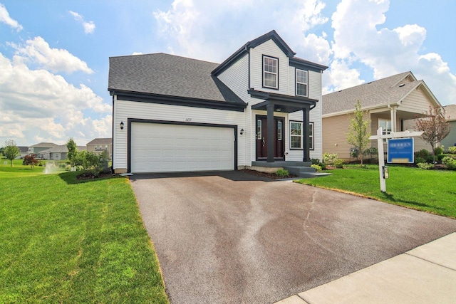 607 Virginia St, Elburn, IL 60119 - traditional-style home with driveway, a garage, a front lawn, and a shingled roof
