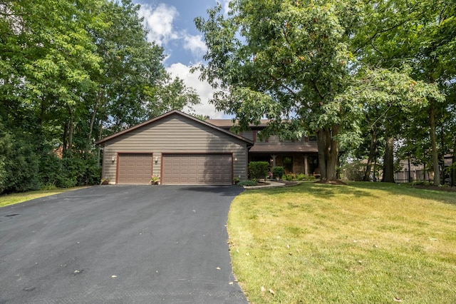 view of front of property featuring a garage and a front lawn