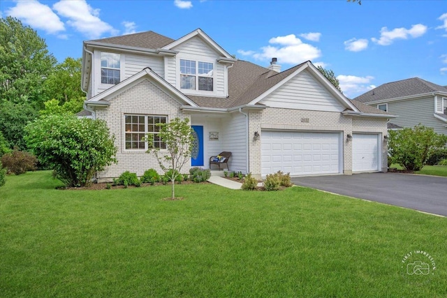 view of front of home with a garage and a front lawn