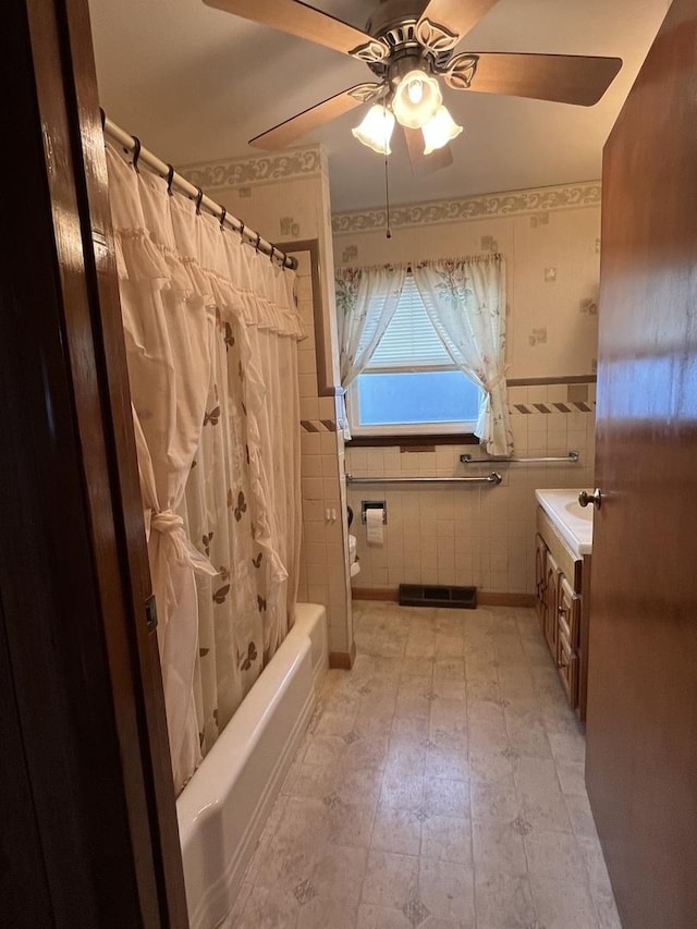 bathroom featuring vanity, tile walls, shower / bath combination with curtain, and ceiling fan