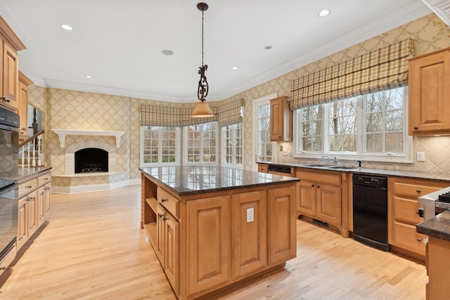 kitchen featuring hanging light fixtures, ornamental molding, sink, and a kitchen island