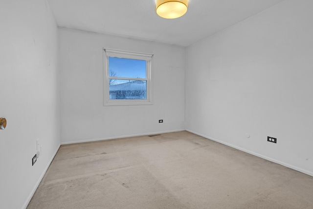 unfurnished room with light carpet