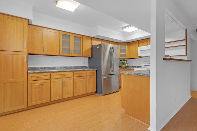 kitchen featuring range, stainless steel fridge, and light hardwood / wood-style floors