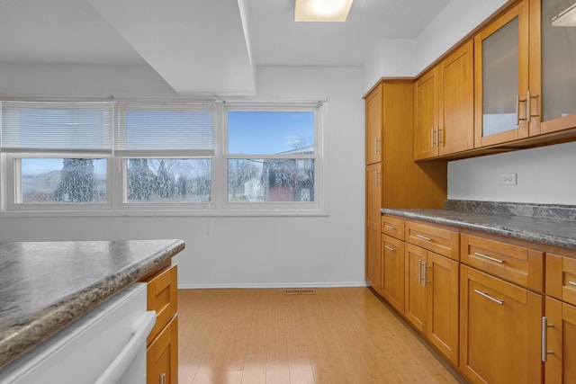 kitchen with white dishwasher and light wood-type flooring