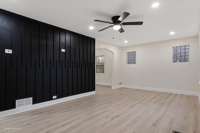 empty room with ceiling fan and light wood-type flooring