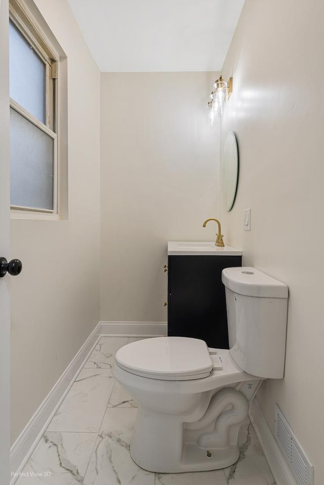 bathroom featuring vanity and toilet