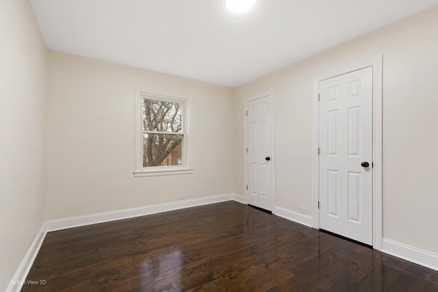 spare room featuring dark hardwood / wood-style floors