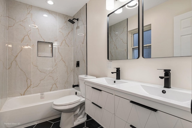 full bathroom with tiled shower / bath combo, vanity, tile patterned floors, and toilet