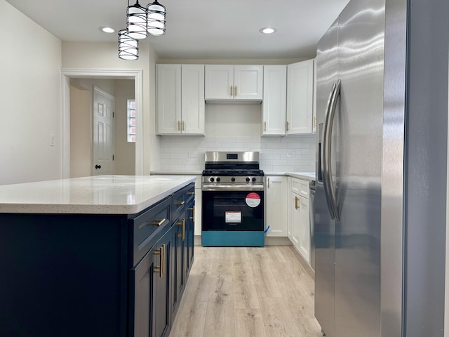 kitchen featuring pendant lighting, blue cabinetry, white cabinetry, stainless steel appliances, and light wood-type flooring