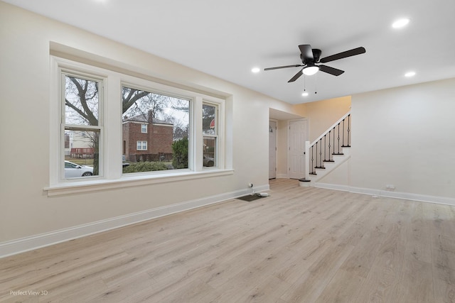 unfurnished living room with light hardwood / wood-style flooring and ceiling fan