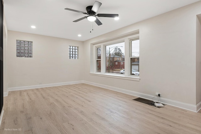 empty room with ceiling fan and light wood-type flooring