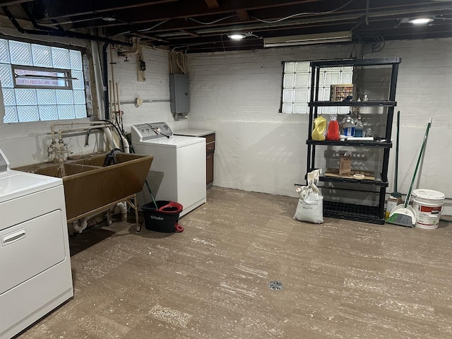 basement with washer and dryer, sink, and electric panel