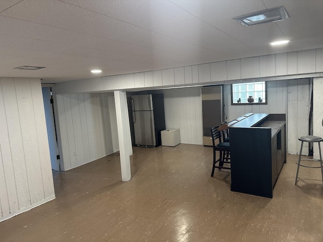 basement featuring stainless steel fridge