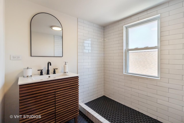 bathroom featuring vanity and a tile shower