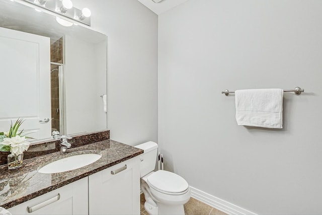 bathroom with tile patterned flooring, vanity, a shower, and toilet