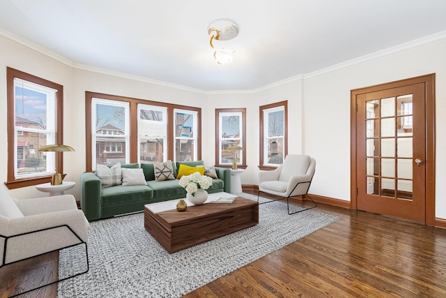 living room with dark wood-type flooring, ornamental molding, and a wealth of natural light