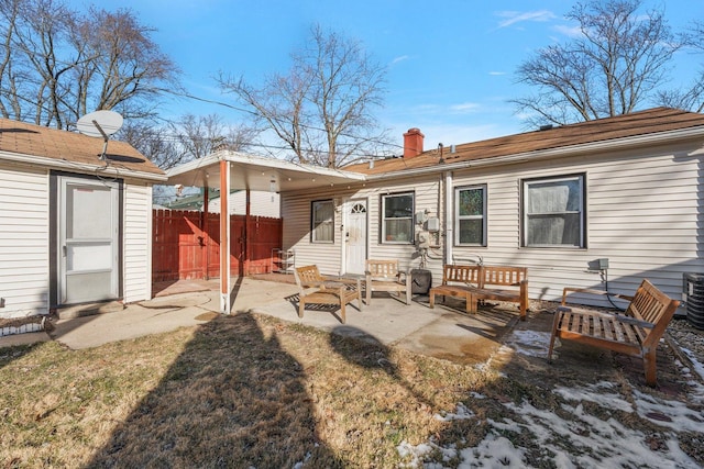 rear view of house featuring a yard and a patio area