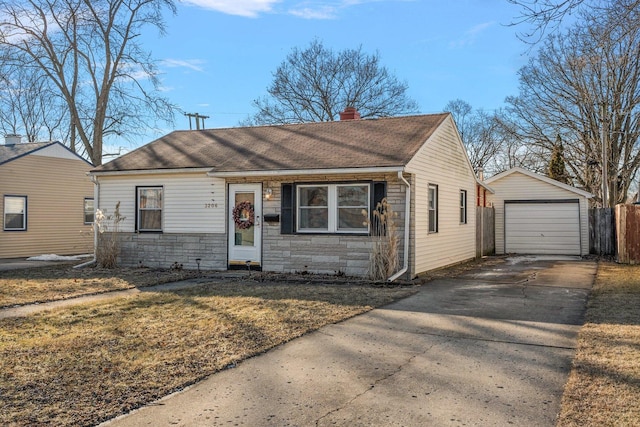 view of front of home with an outbuilding, a garage, and a front lawn