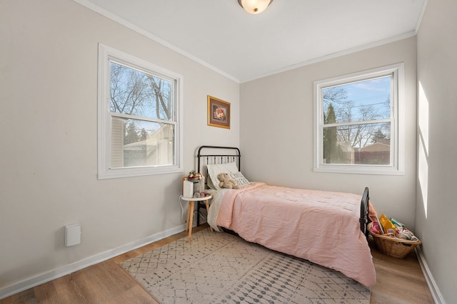 bedroom featuring hardwood / wood-style flooring and ornamental molding