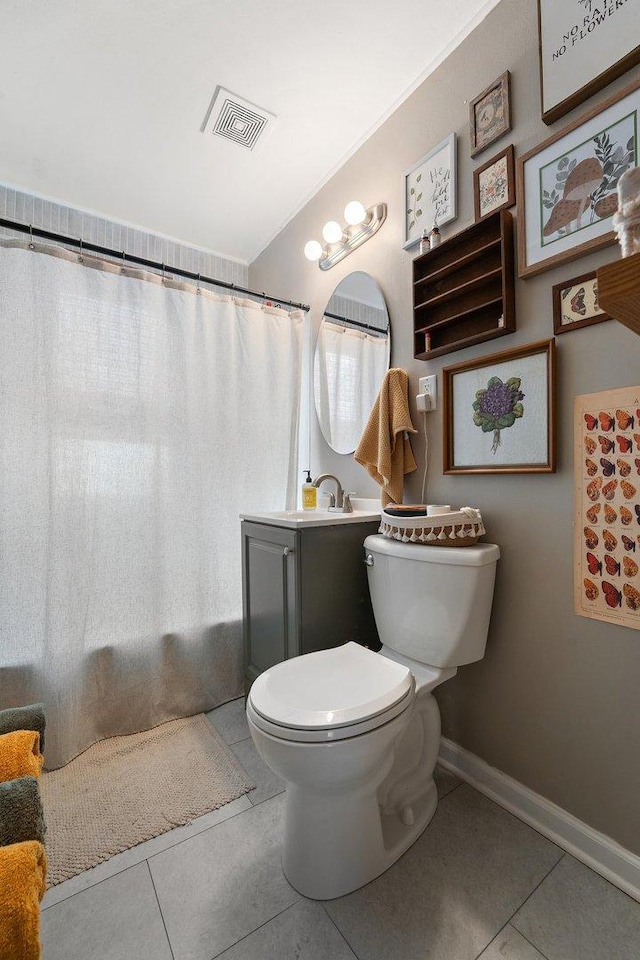 bathroom with vanity, curtained shower, tile patterned floors, and toilet