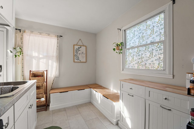 interior space featuring sink and light tile patterned floors