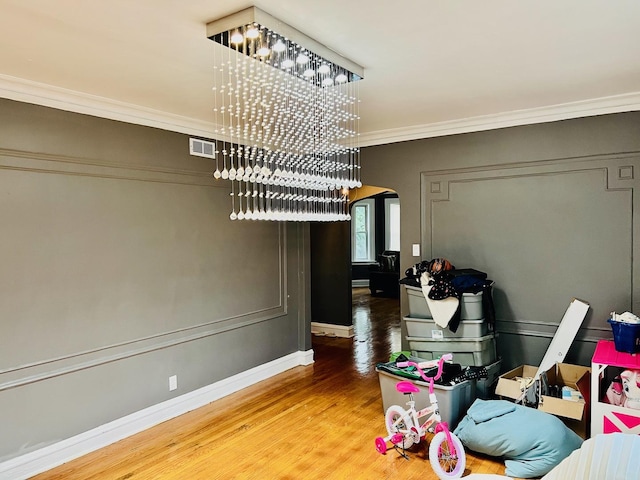 interior space featuring crown molding and wood-type flooring