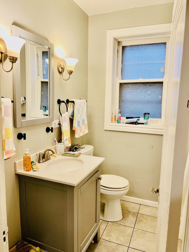 bathroom featuring vanity, toilet, and tile patterned flooring