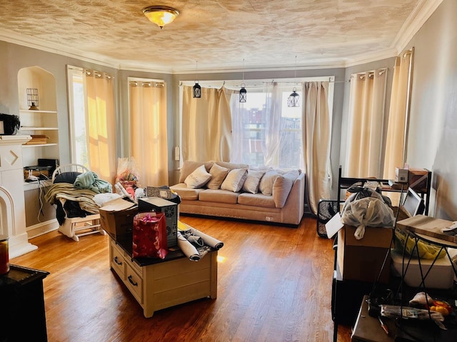 living area with ornamental molding and hardwood / wood-style floors