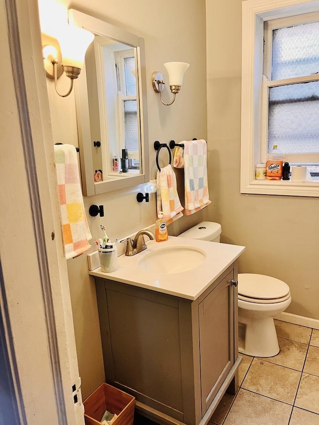 bathroom with vanity, tile patterned floors, and toilet