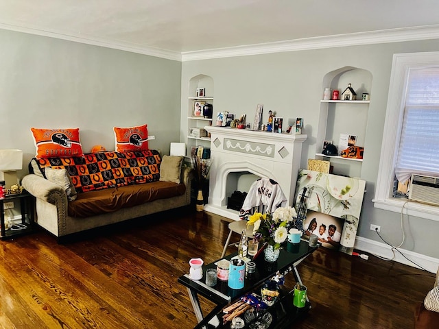 living room with crown molding, built in shelves, and dark hardwood / wood-style floors