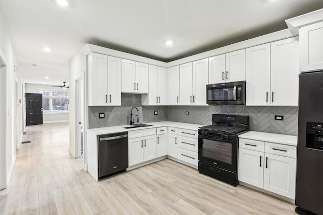 kitchen featuring dishwashing machine, a sink, fridge with ice dispenser, stainless steel microwave, and gas stove