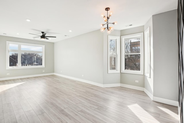 interior space with a healthy amount of sunlight, light wood finished floors, visible vents, and baseboards