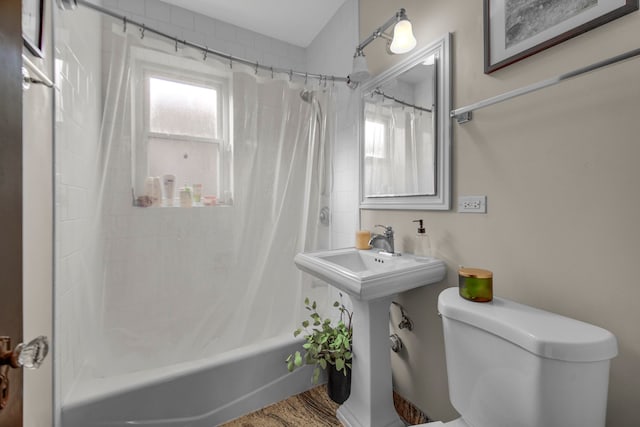 bathroom featuring shower / bath combo and toilet